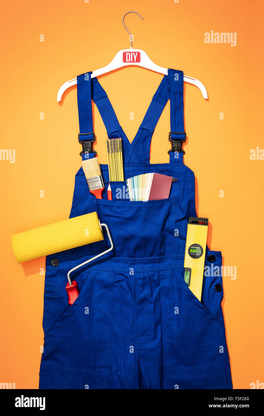 Painter and decorator work uniform with tools and roller paint home