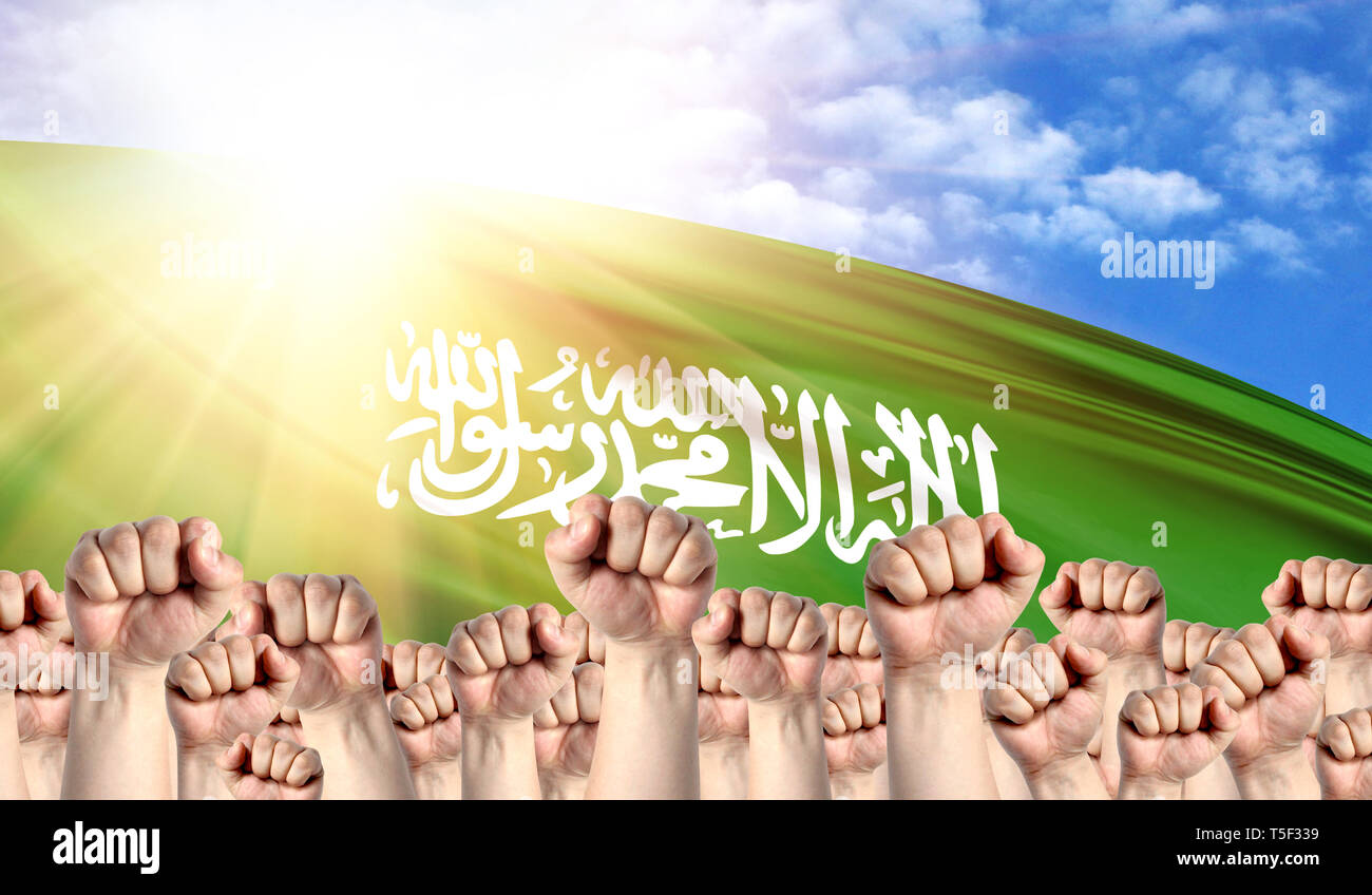 Labor Day concept with fists of men against the background of the flag of Saudi Arabia Stock Photo