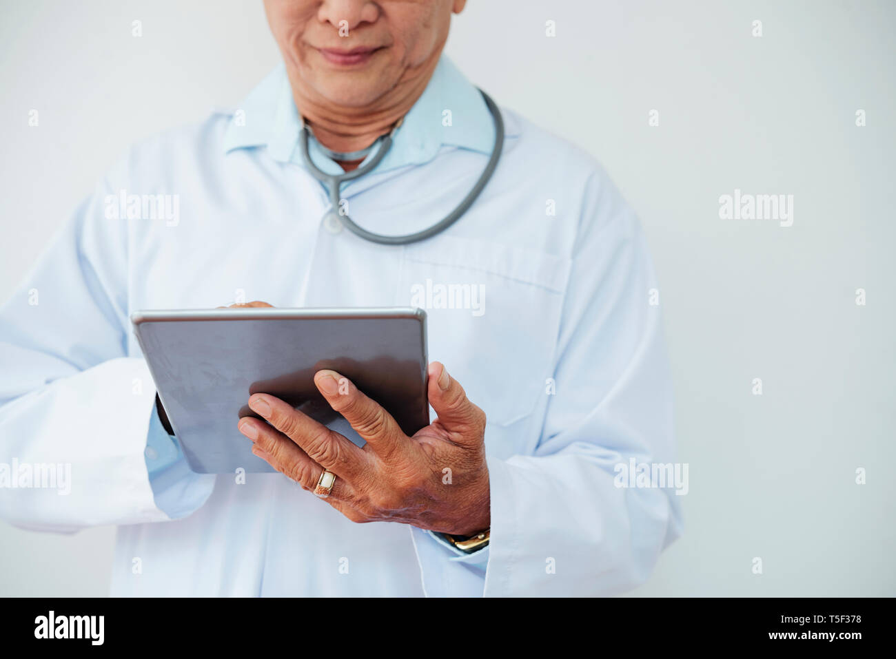 Doctor working on tablet computer Stock Photo