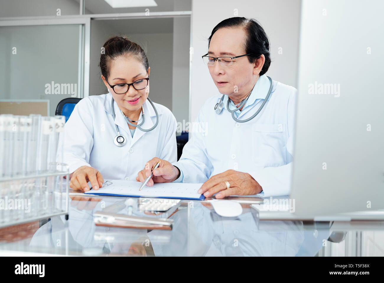 Doctors discussing medical history Stock Photo Alamy
