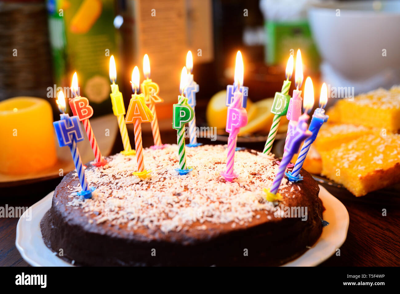a birthday cake with lighted candles, inscription Happy birthday Stock