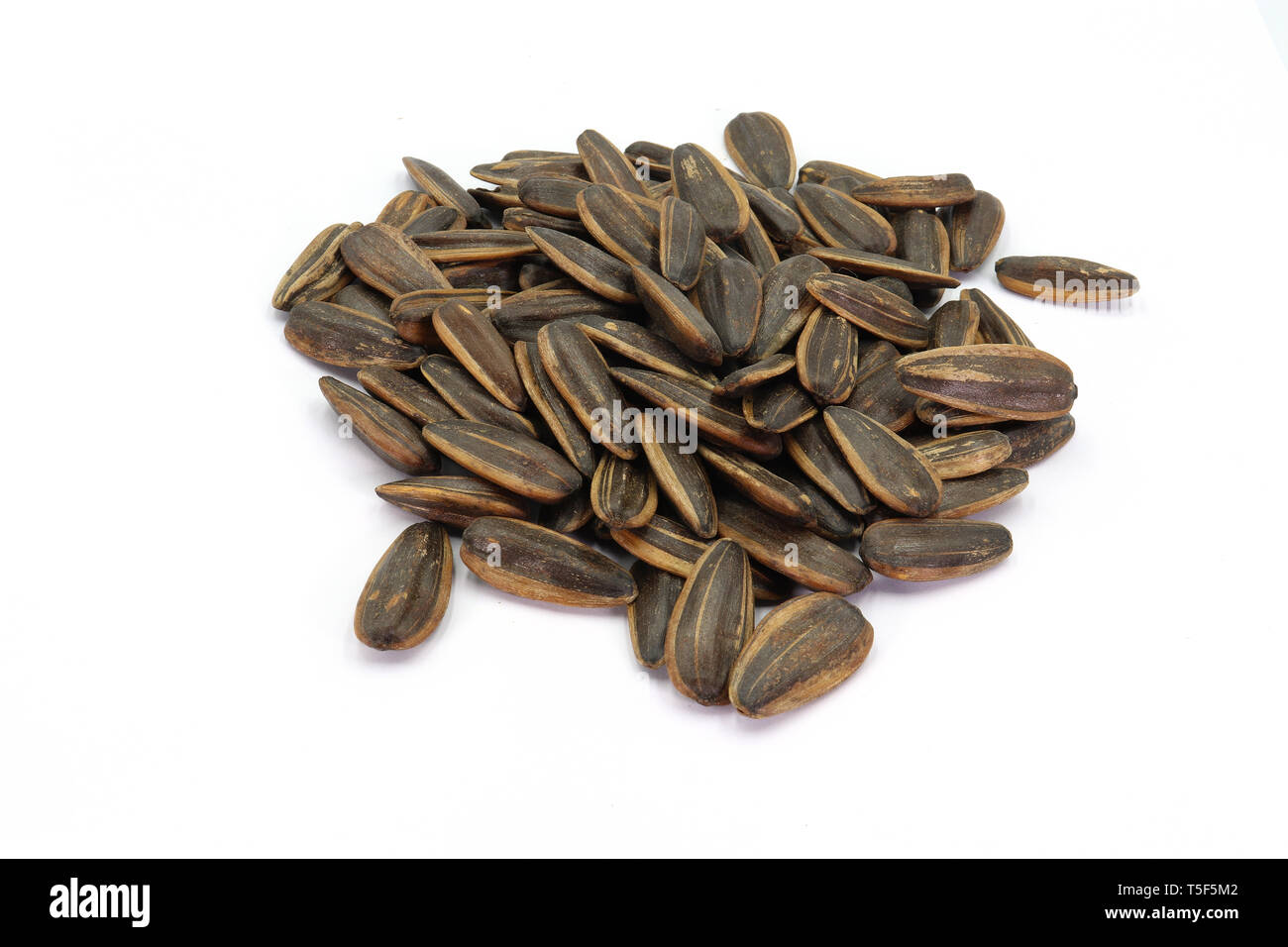 a pile of sunflower seeds isolated on white background. High resolution