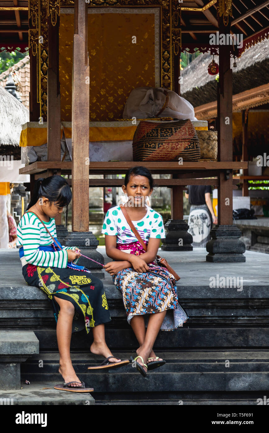 Young Local Girls at a Temple in Bali, Indonesia Stock Photo