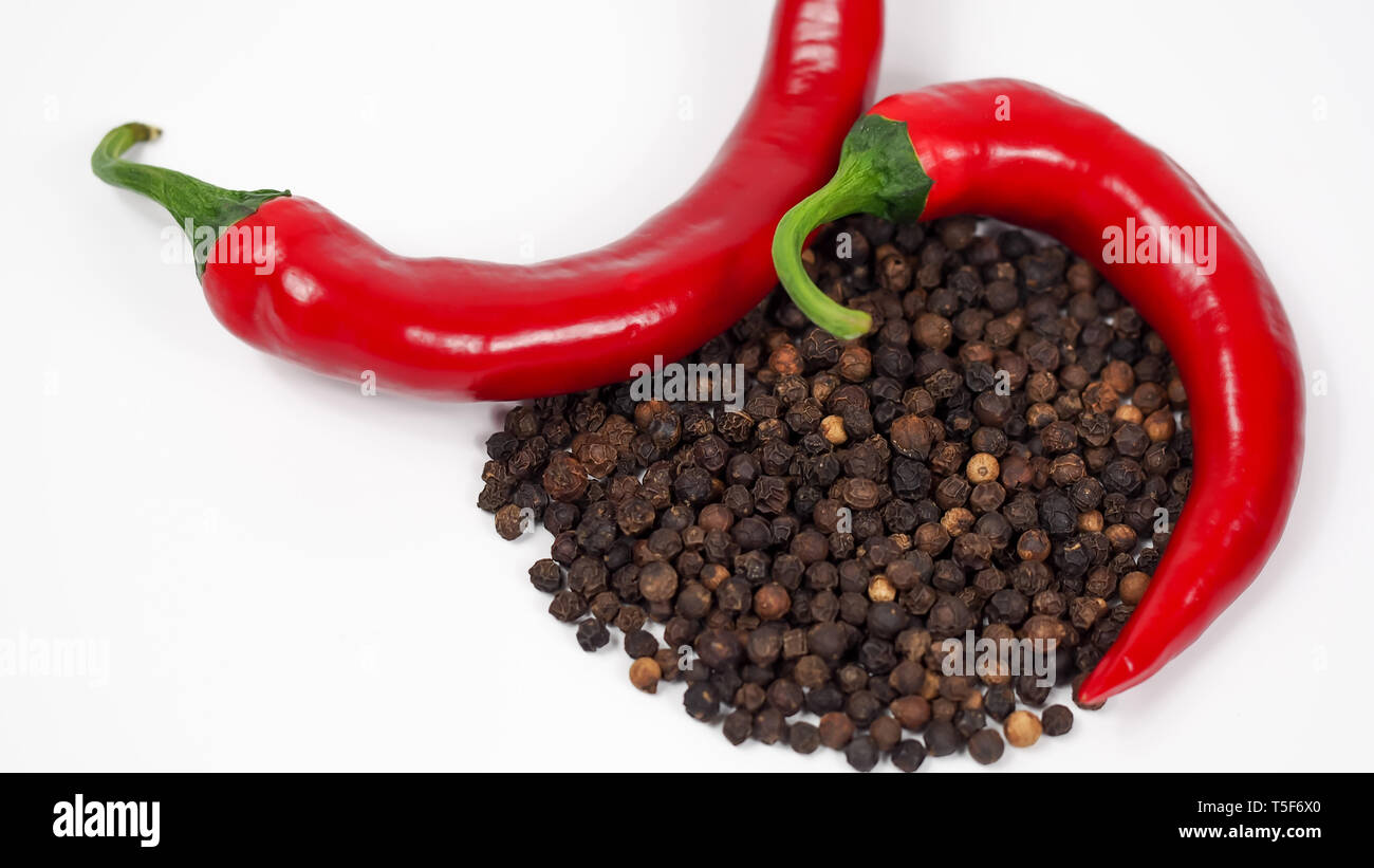 red spicy chili pepperoni and a handful of brown peppercorns with white