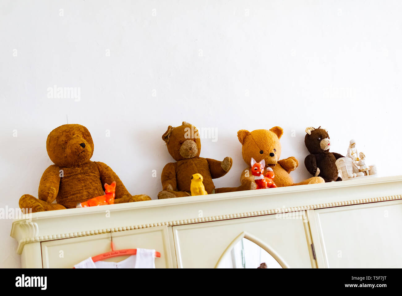 Old Retro Teddy Bears Looking From The Cabinet In Room For Kids