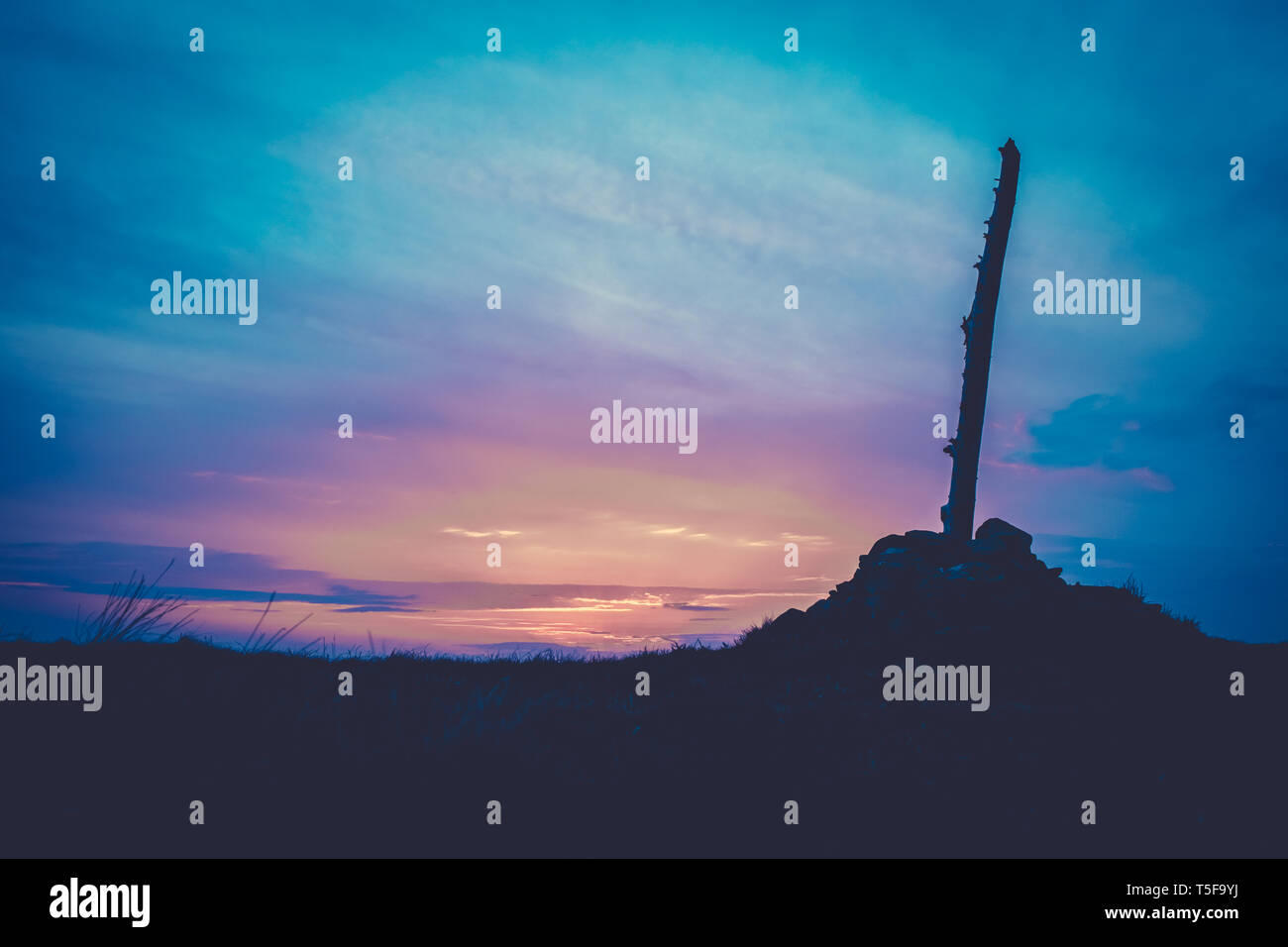 Beautiful Cairn (Pile of Stones Marking a Mountain Top) At Sunset In Scotland With Copy Space Stock Photo