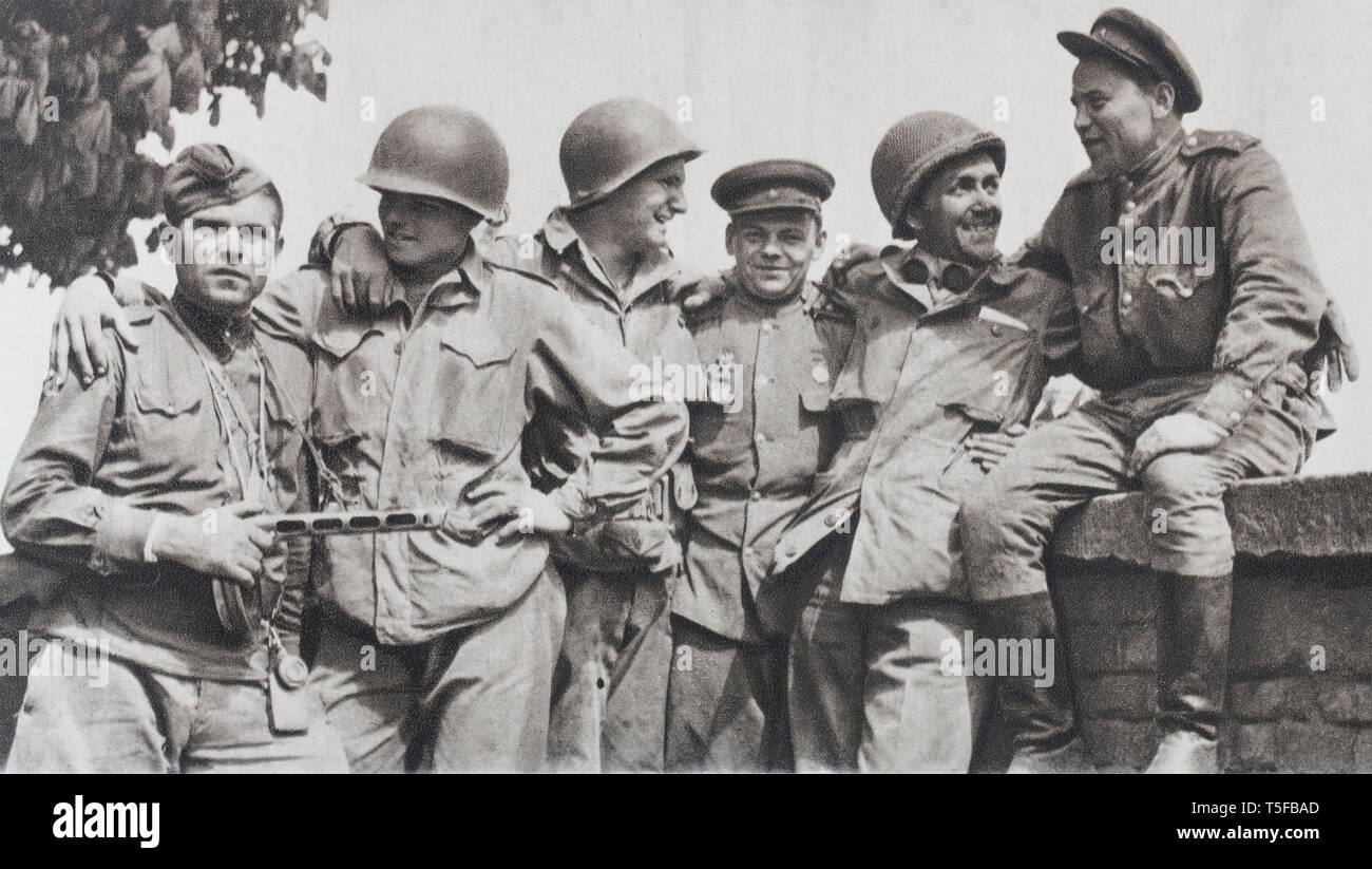 Meet Torgau (1945). American soldiers and Russian soldiers fraternize after their meeting on the river Elbe, at 140 km south of Berlin. Stock Photo