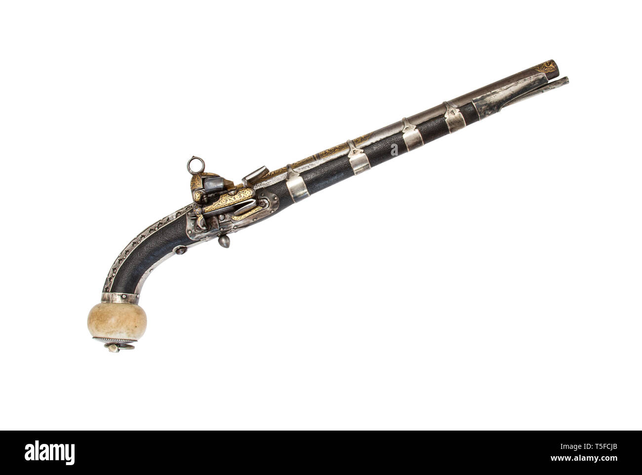 The 19th century Caucasian flintlock pistol with gilded barrel. Stock Photo