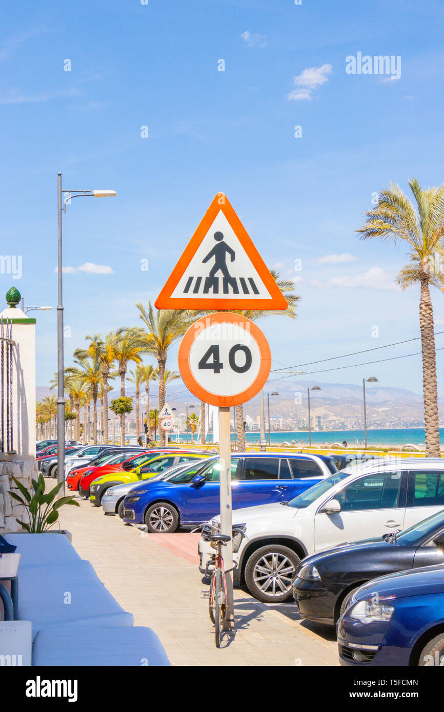 speed limit and pedestrian crossing signs by the beach in Alicante