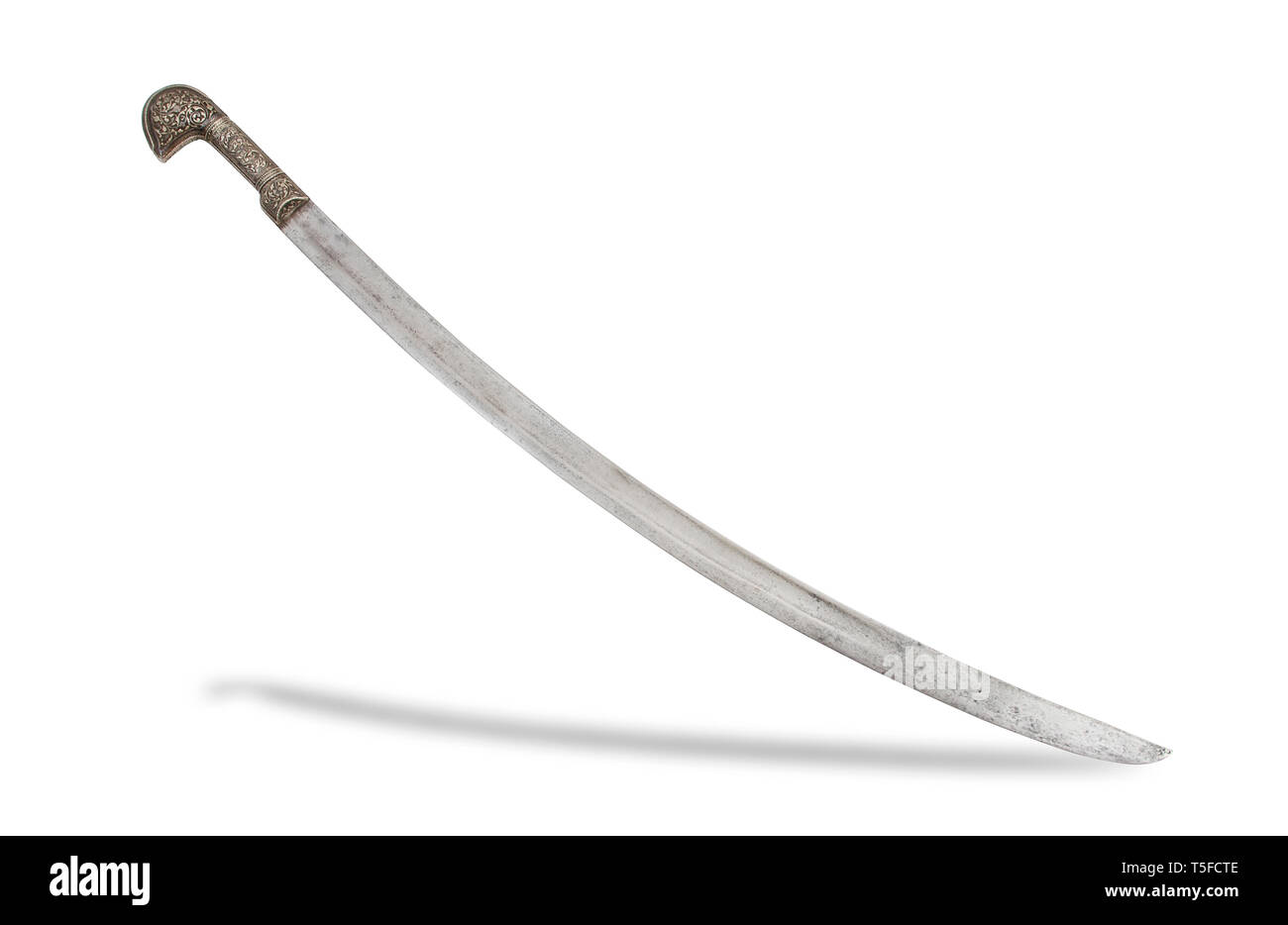 Caucasian shashka sword with large silver pommel decorated with deep engraving finished with niello. Stock Photo
