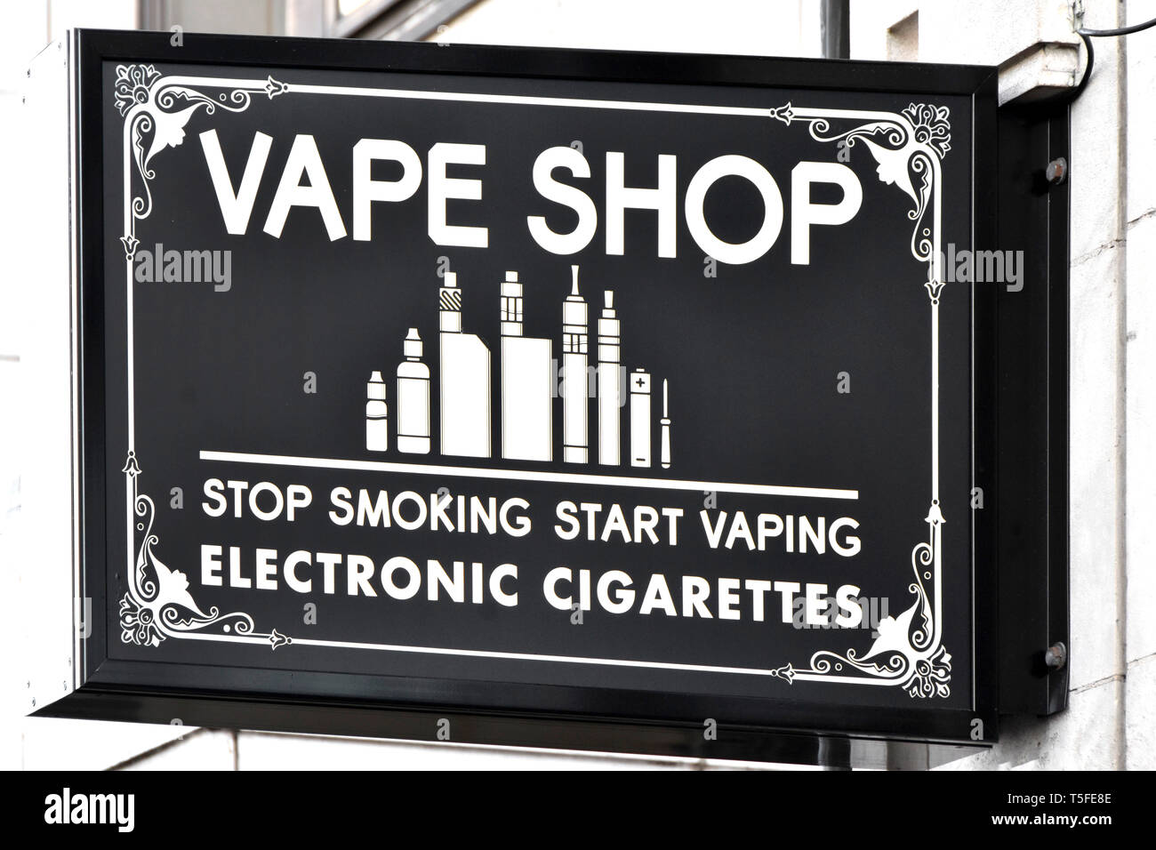 Vape shop sign selling e cigarette or electronic cigarettes as handheld electronic devices with e juice & other smoking accessories London England UK Stock Photo