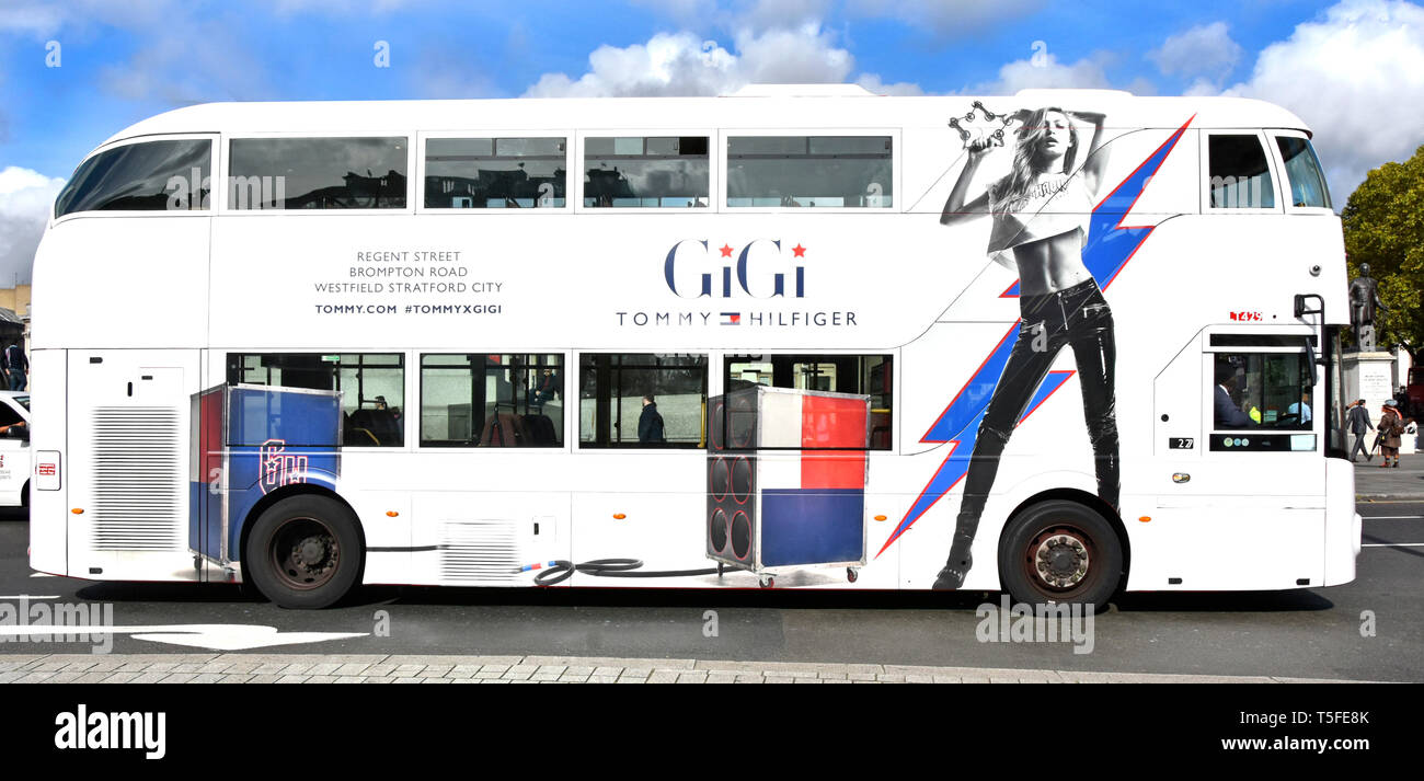 Advertising on side of white London public transport double decker bus &  model promotion GiGi Tommy Hilfiger fashion store at London locations UK  Stock Photo - Alamy