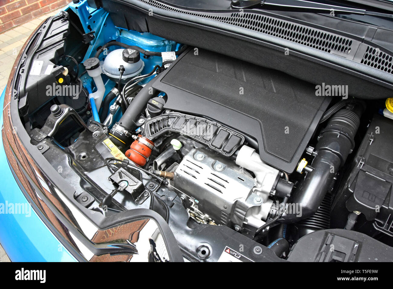 Close up view under raised bonnet hood of 2019 blue Citroen C3 Aircross mini SUV new car with petrol engine components in compact layout England UK Stock Photo