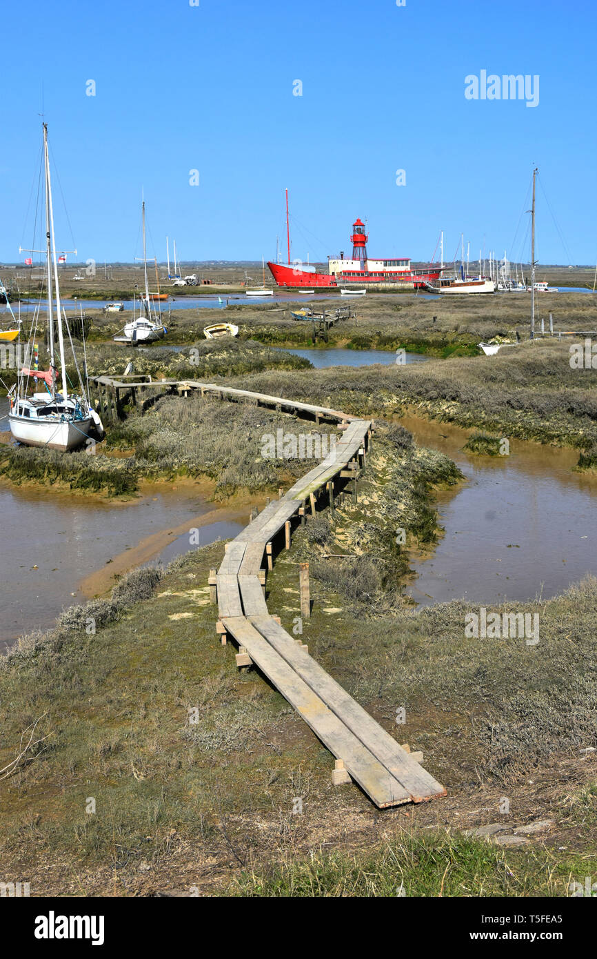 Essex coast landscape & coastal countryside from Tollesbury Wick with River Blackwater salt marshes mud yacht mooring area & moored red lightship UK Stock Photo
