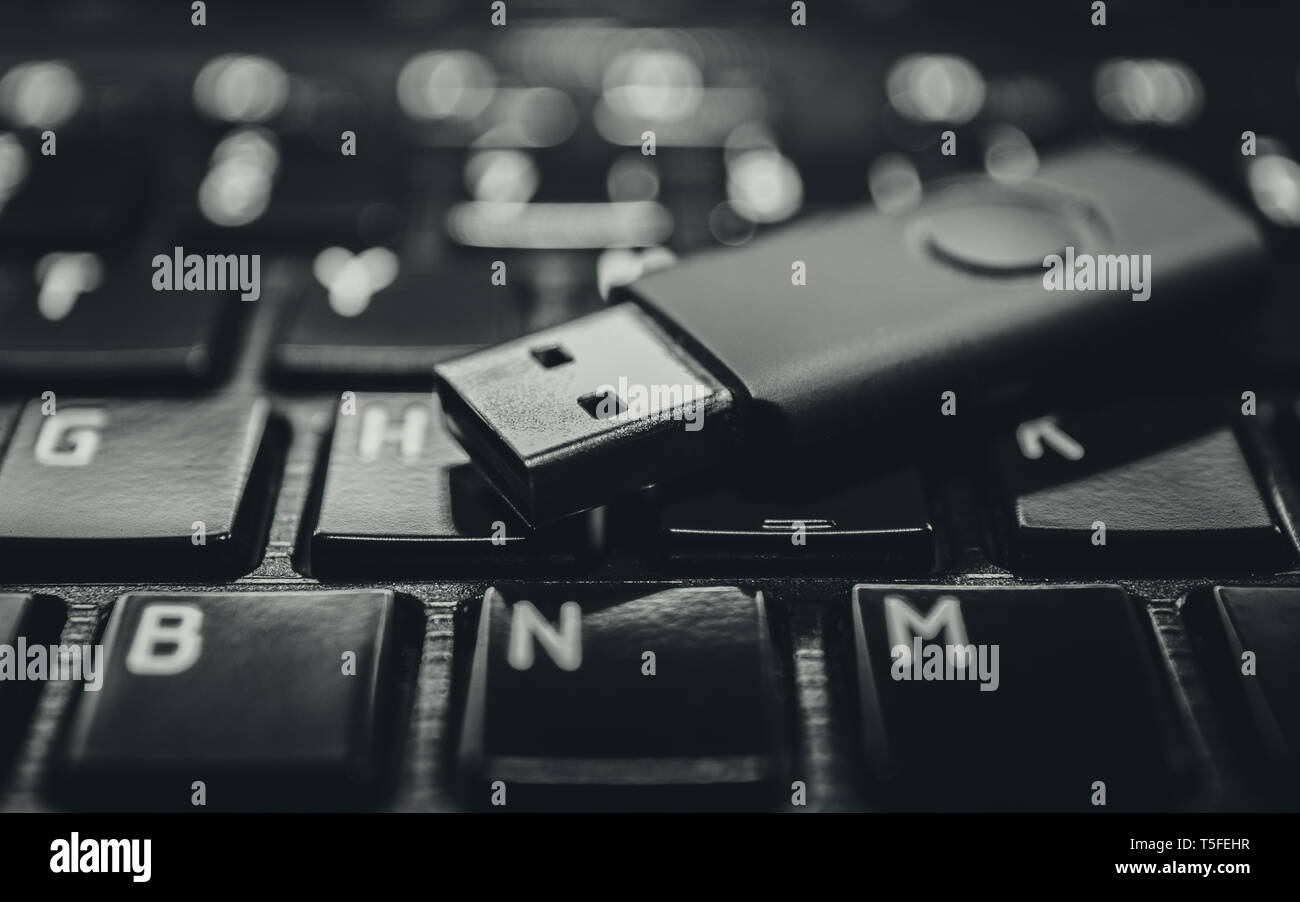 USB pen drive on black laptop keyboard Stock Photo