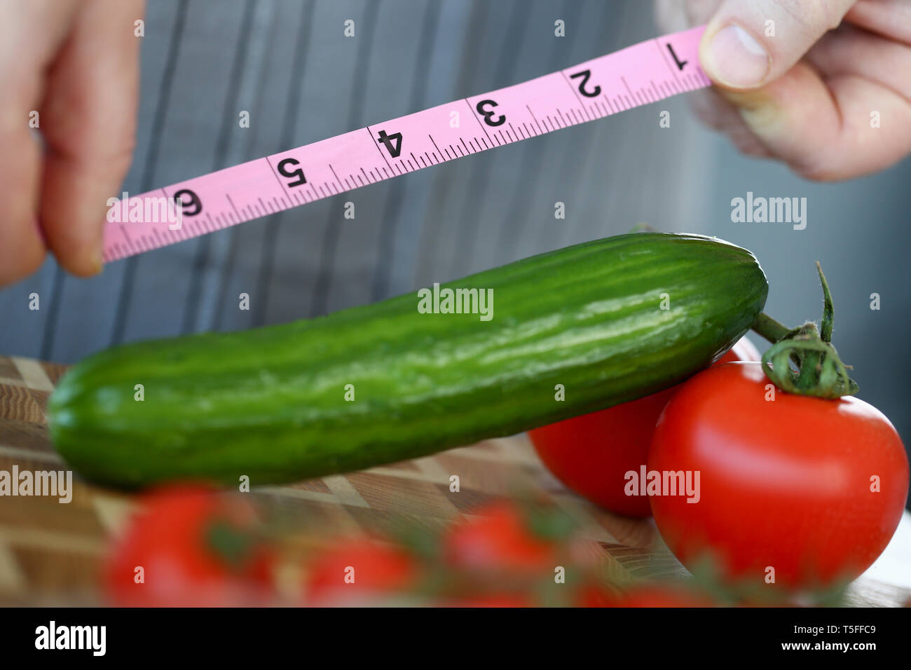 Male Hands Measure Green Ripe Cucumber Length Stock Photo