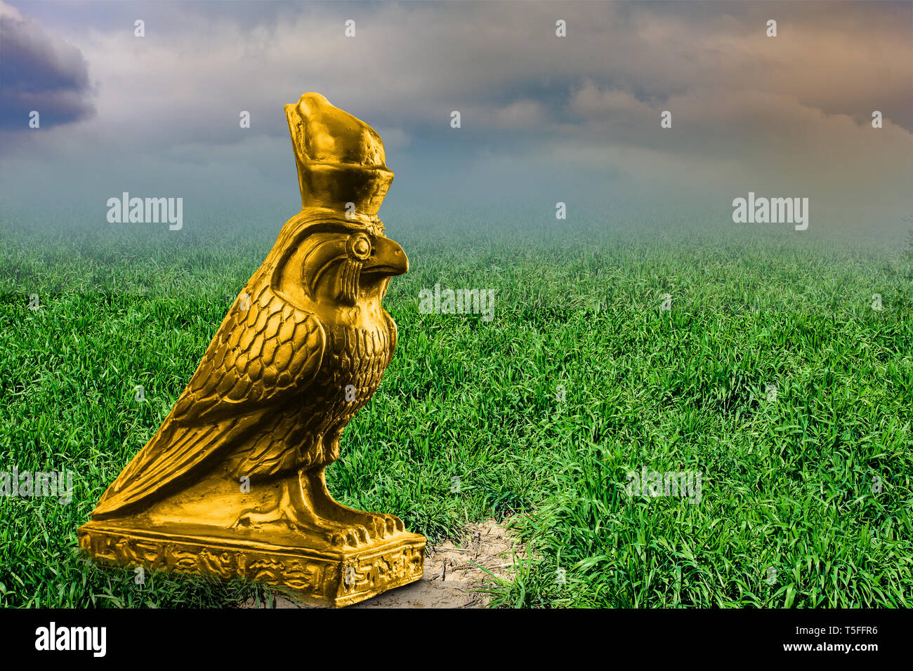 Golden statue of the Horus god on grass Stock Photo Alamy
