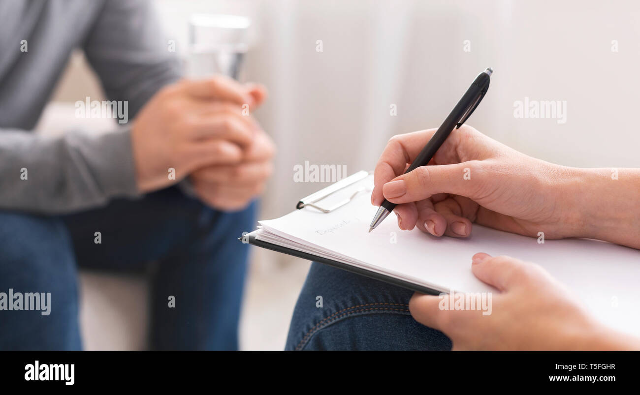 Psychologist taking notes during session with patient Stock Photo Alamy