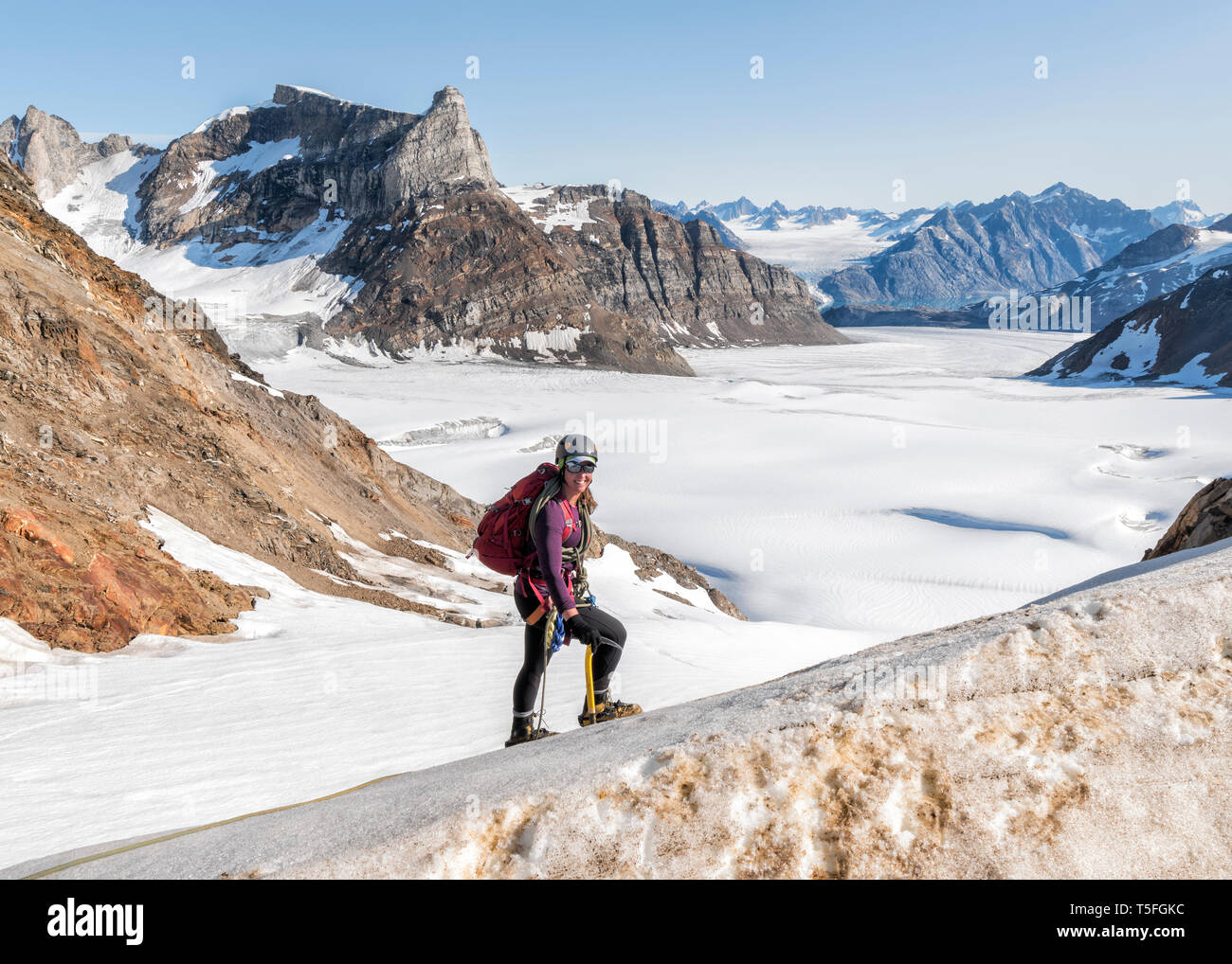 Greenland, Sermersooq, Kulusuk, Schweizerland Alps, portrait of smiling mountaineer in snow Stock Photo