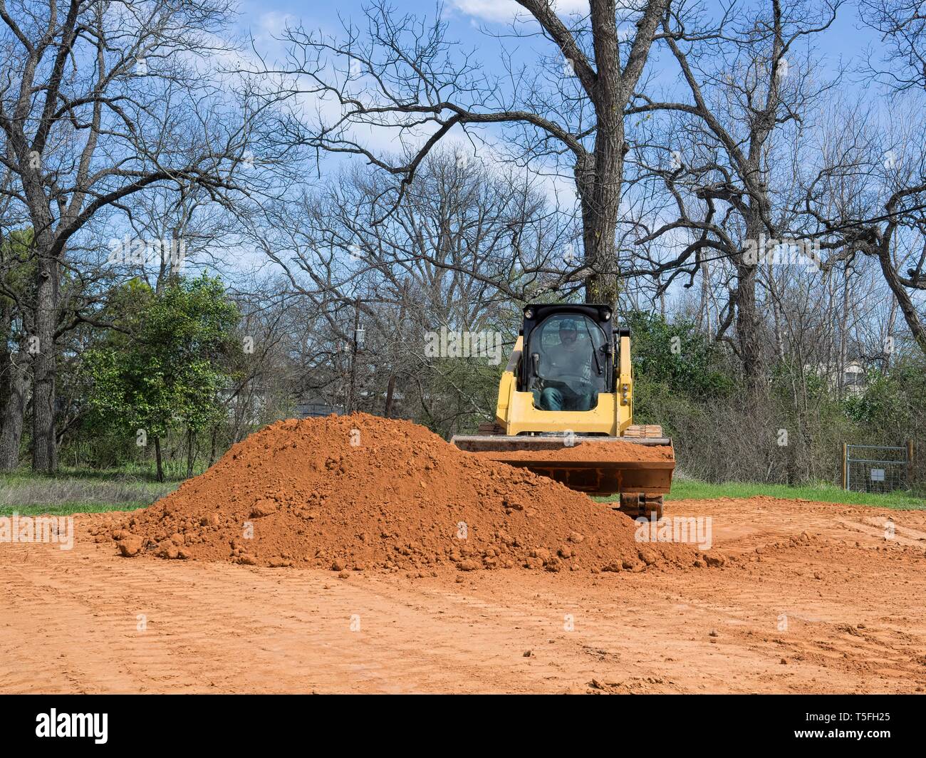 Skid Steer Moving mounds of Dirt Stock Photo