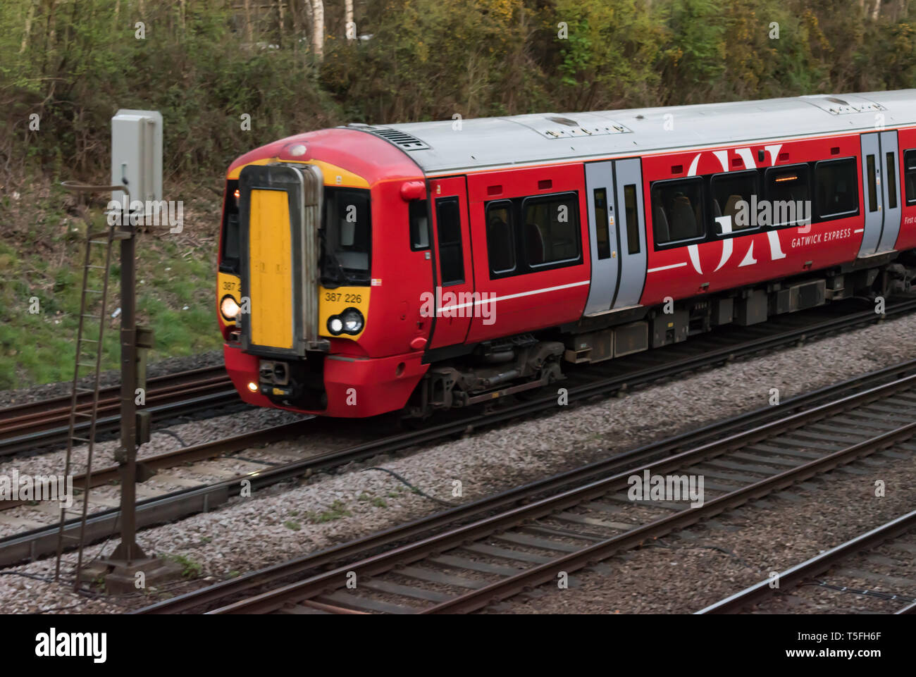 Crawley, West Sussex, UK - April 17 2019: Close up of the front carriage of a Gatwick Express train service as it passes a signal. Stock Photo