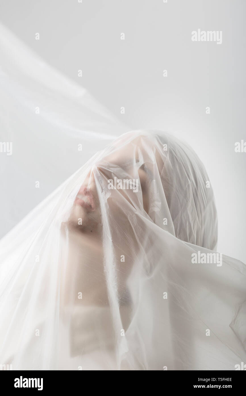 Graceful woman trapped in a veil Stock Photo