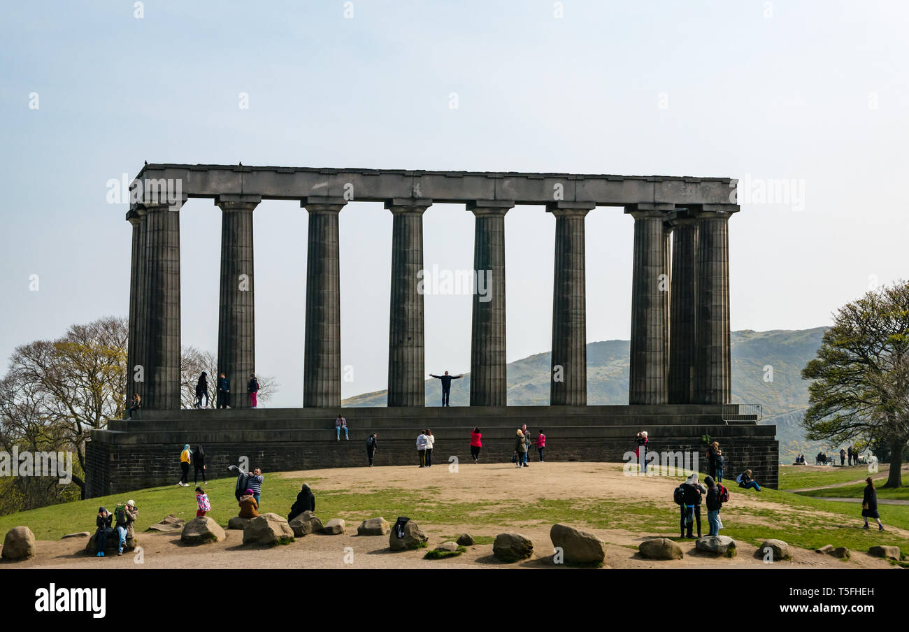 Tourists climbing and standing on National Monument of Scotland, Calton Hill, Edinburgh, Scotland, UK Stock Photo