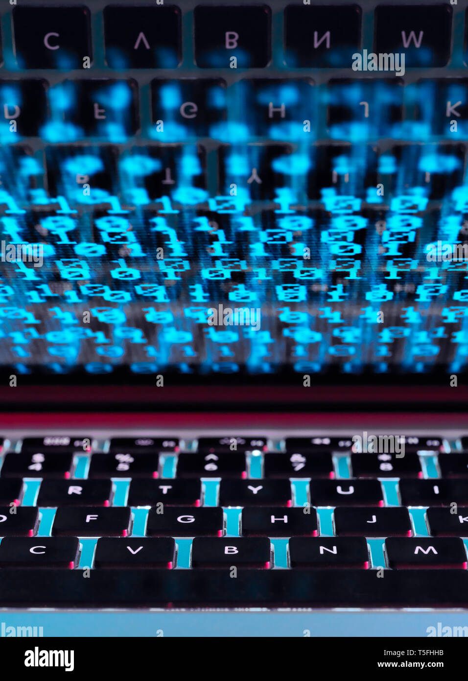 Computer virus infecting a laptop computer with a virus Stock Photo