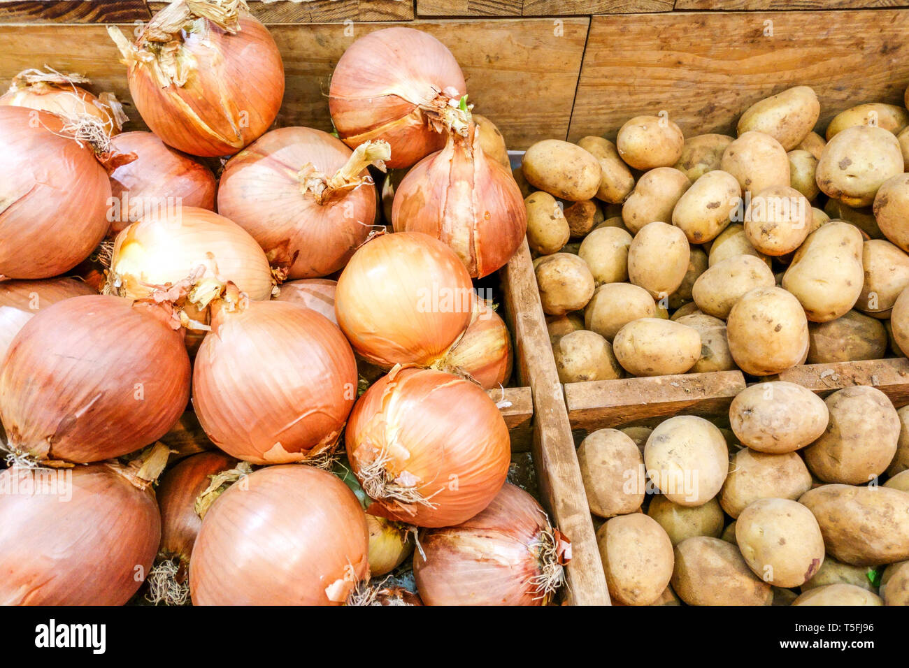 Onions potatoes in a wooden box on the market in Spain Stock Photo