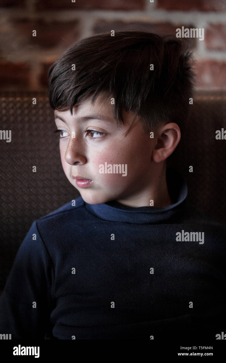 Mixed Race Asian Caucasian Boy With Arms Crossed Wearing Blue