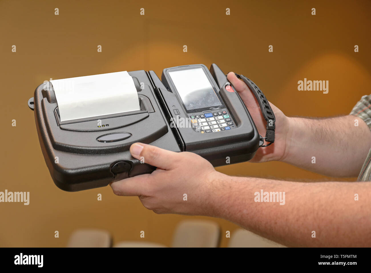 Man Holding Portable Barcode Printer and Reader Computer Device Stock Photo