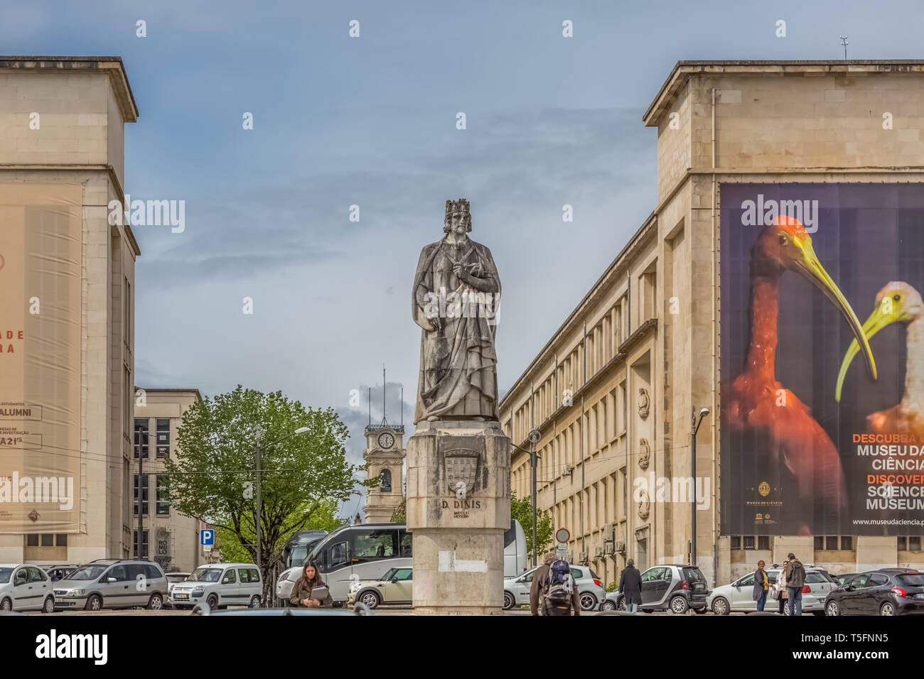 Coimbra / Portugal - 04 04 2019 : View of the statue of king D. Dinis, in the square of the University of Coimbra, surrounding buildings, people and v Stock Photo