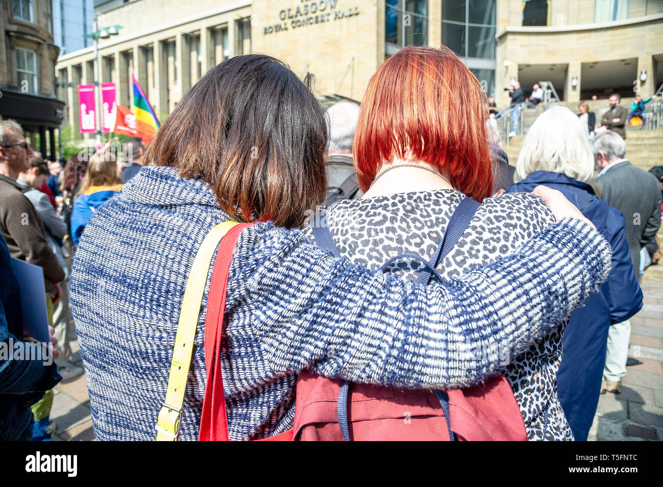 Two women are seen embracing each other during the vigil. People turned out to pay their respects to the Belfast born journalist Lyra McKee, 29, who was shot dead by members of the New IRA whilst while covering riots that were happening in Derry, also known as Londonderry. The NUJ Glasgow branch held a vigil for those wishing to pay their respects for the slain journalist. Stock Photo