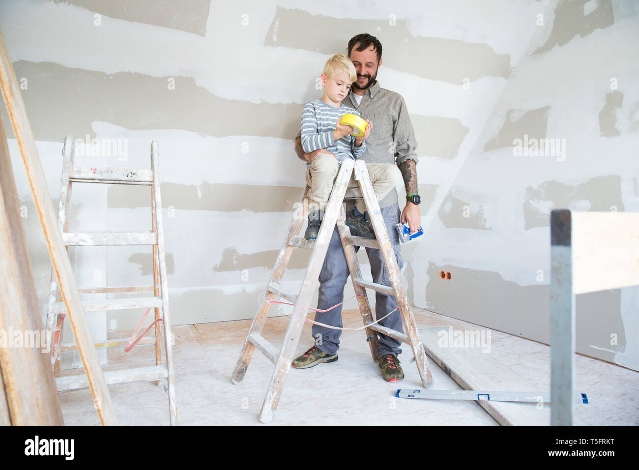 Father and son working on loft conversion Stock Photo
