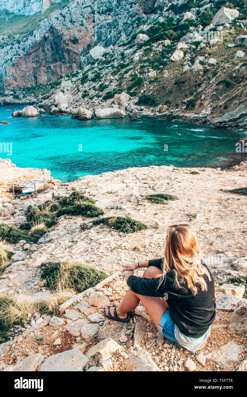Girl looking onto water bay of Balearic Island Mallorca Majorca Stock Photo