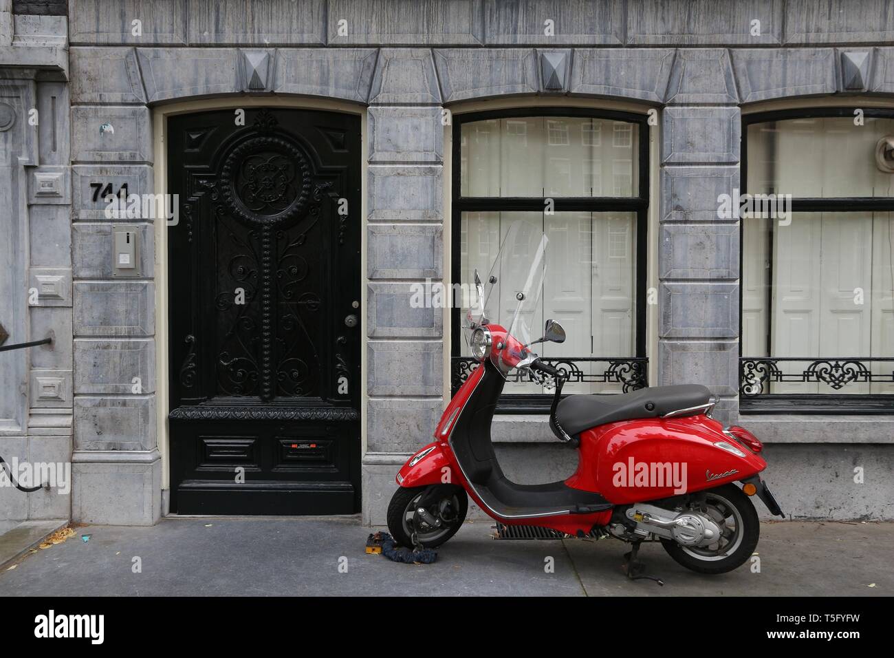 AMSTERDAM, NETHERLANDS JULY 10, 2017 Red Piaggio Vespa scooter