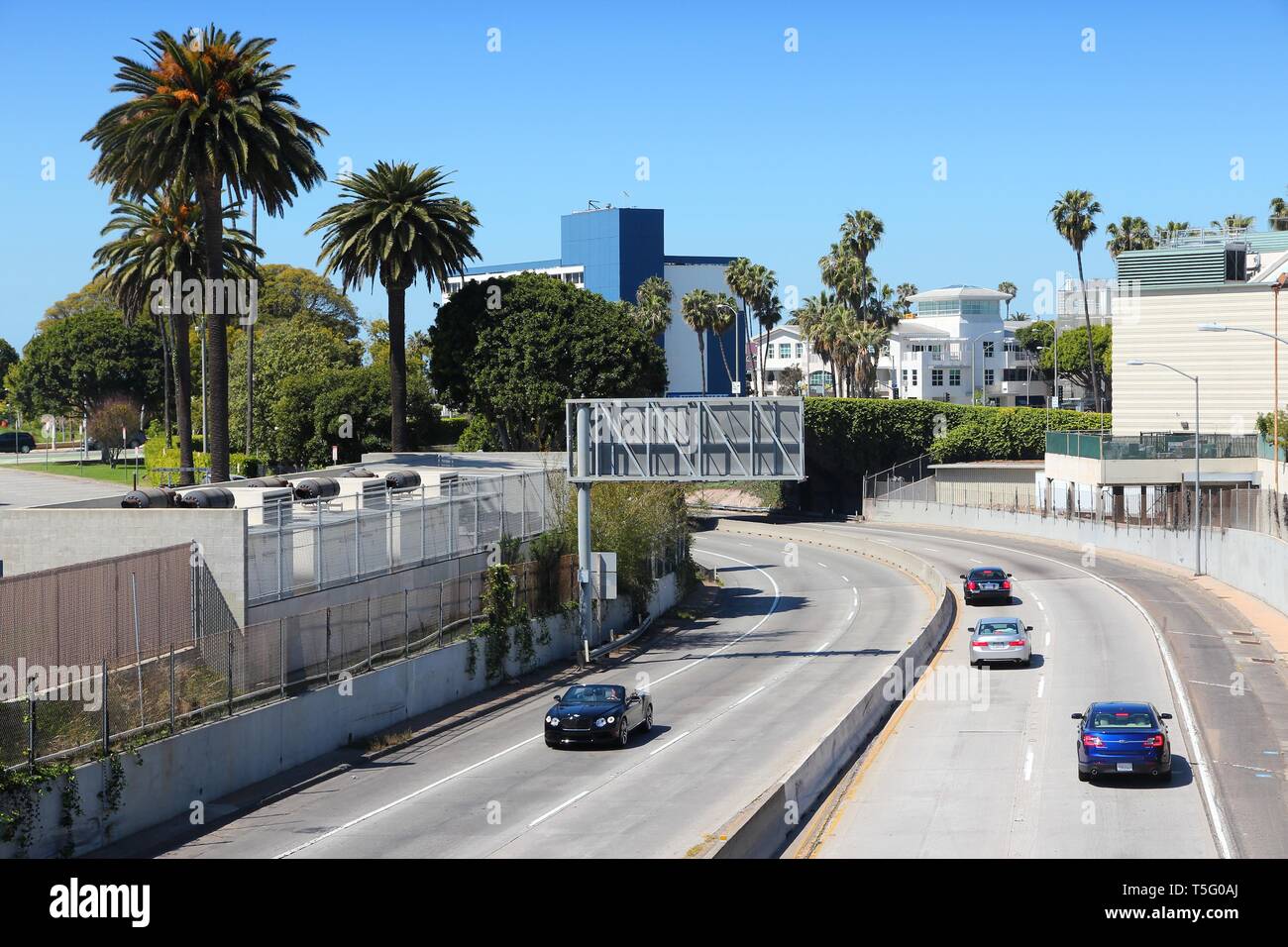 SANTA MONICA, UNITED STATES - APRIL 6, 2014: People drive Interstate 10 highway in Santa Monica, California. The freeway is part of 47,856 miles long  Stock Photo