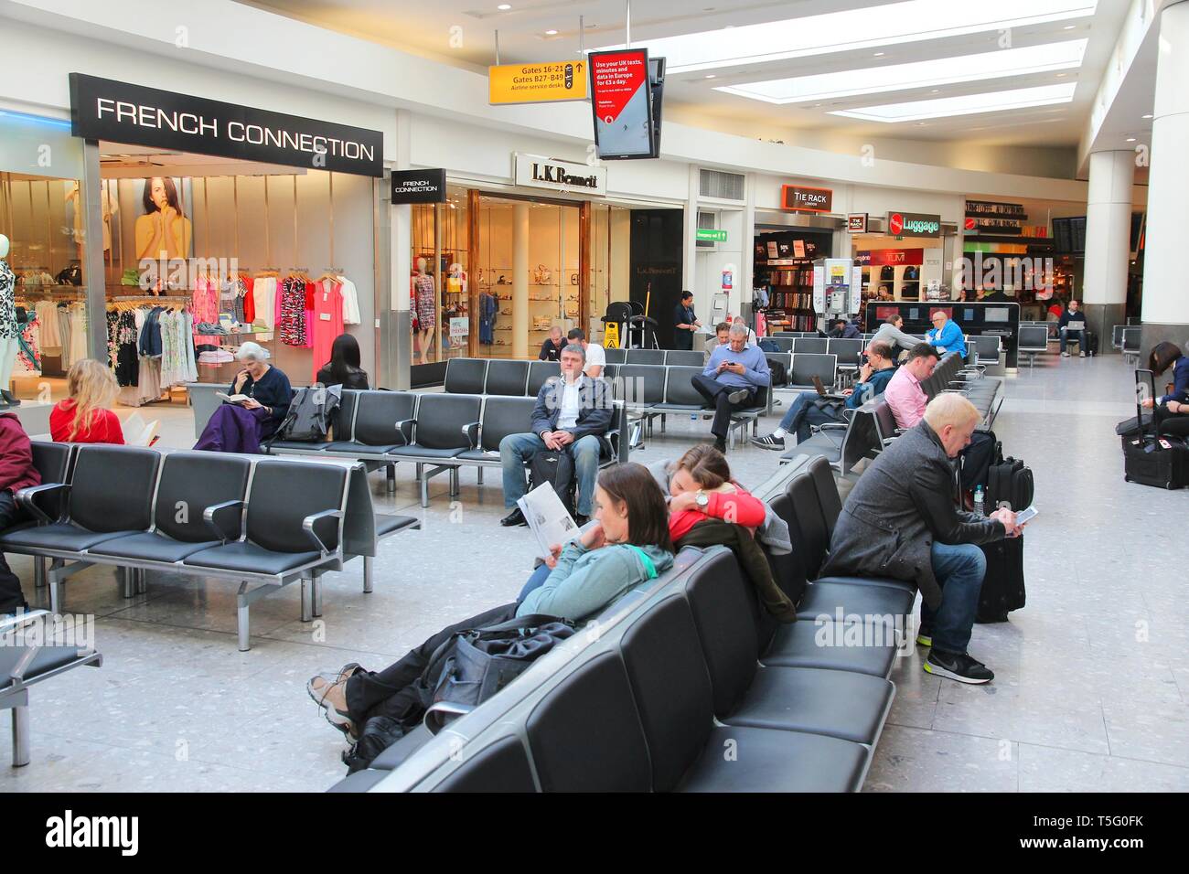 LONDON, UK - APRIL 16, 2014: Passengers wait at London Heathrow Airport in UK. Heathrow is the 3rd busiest airport in the world with 73.4 million pass Stock Photo