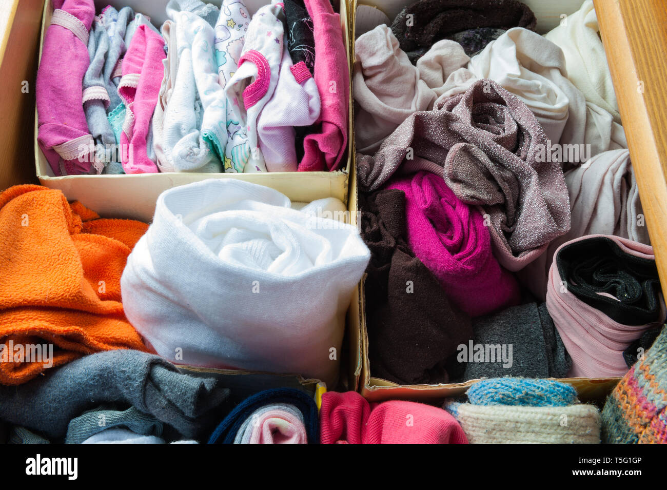box with folded clothes divided into sections Stock Photo Alamy