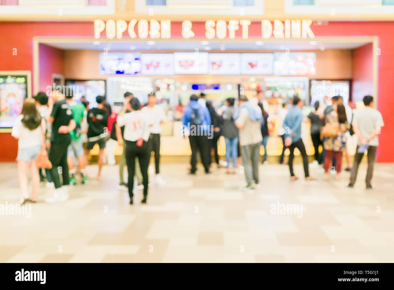 Blurred defocus of People buying popcorn, snack and soft drink in the new modern cinema food and soft drink counters. Blurred cinema lifestyle backgro Stock Photo