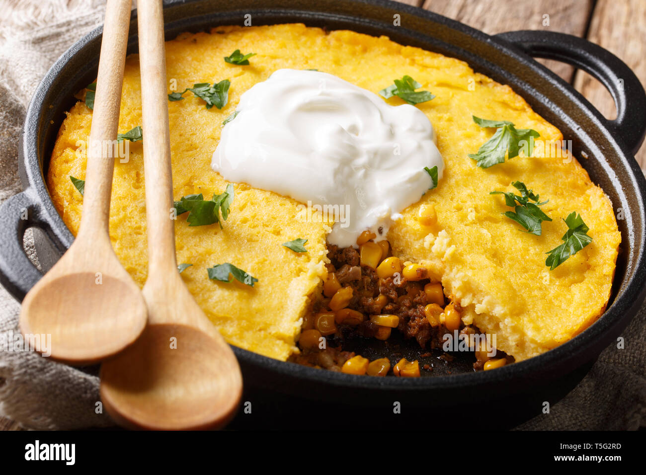 American Tamale corn pie crust and beef filling close-up in a pan on the table. Horizontal Stock Photo