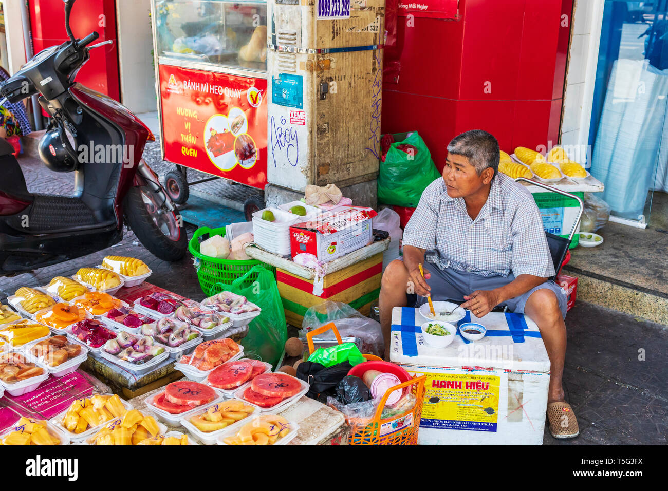 Man selling fresh fruit from an open stall at Ben Thanh street market, Ho Chi Minh City, Saigon, Vietnam, Asia Stock Photo