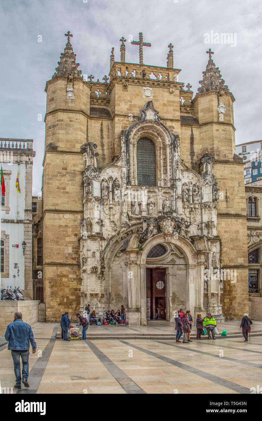 Coimbra / Portugal - 04 04 2019 : View of the Santa Cruz Monastery front facade, romanesque and gothic style, with tourists on street , a National Mon Stock Photo