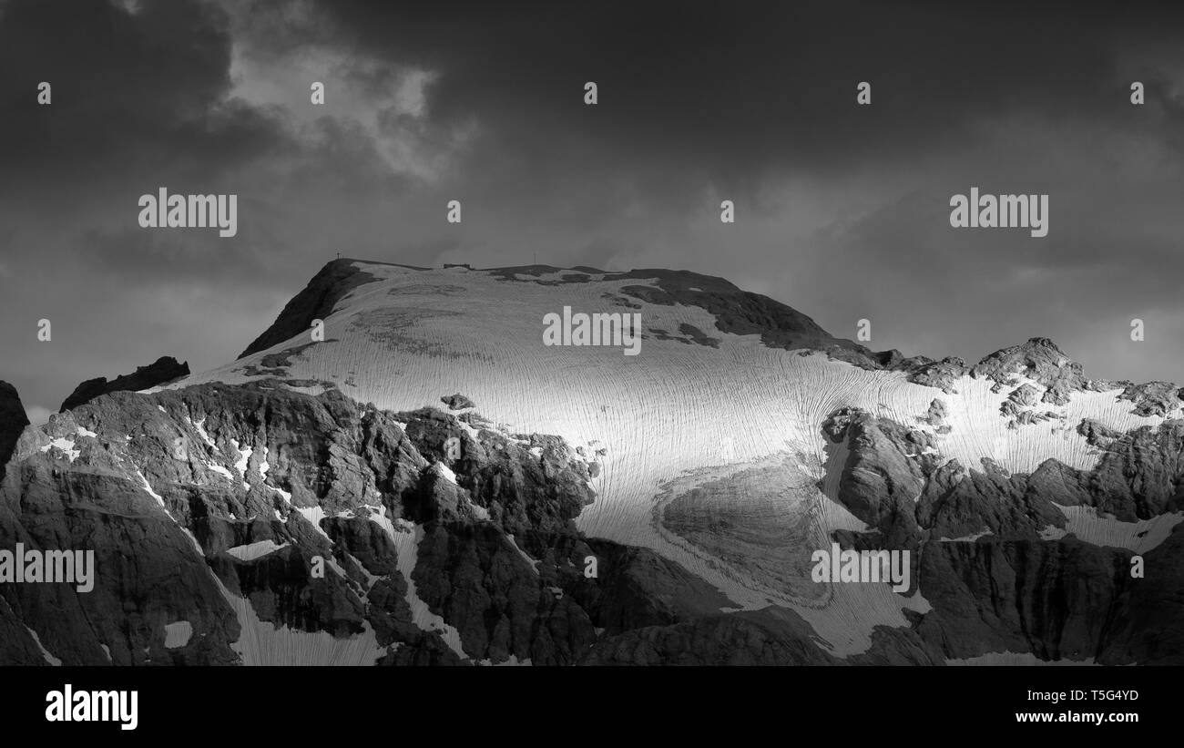 The Marmolada mountain peak, glacier. Punta Penia peak. The Dolomites. Italian Alps. Europe. Black white mountain landscape. Stock Photo