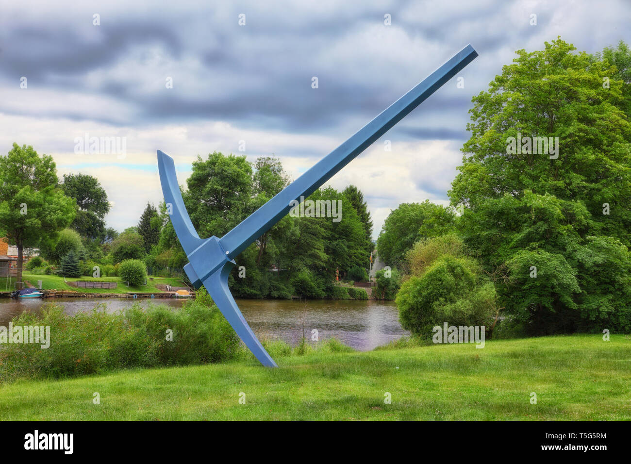 Huge pick axe in front of a river Stock Photo