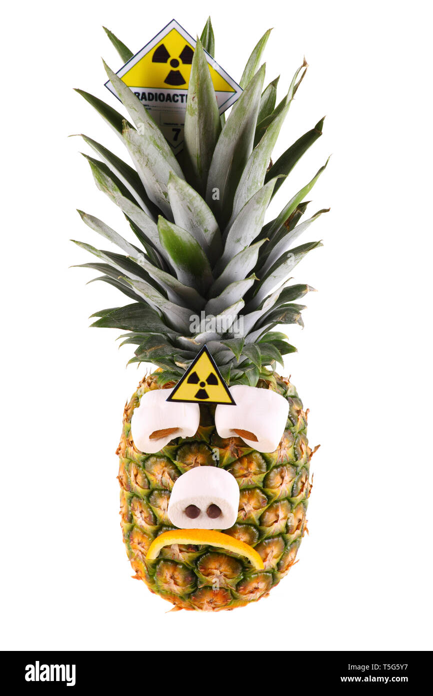 Sad pineapple with radioactive symbol - isolated on a white background. Stock Photo