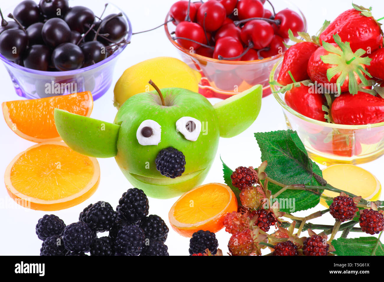 Funny Apple  Yoda with dekoration fruits - cut out Stock Photo