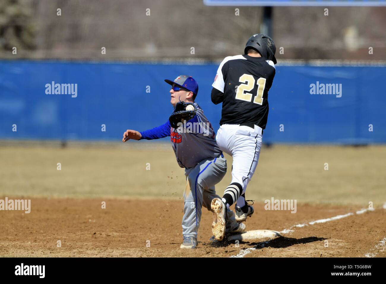Base runner being retired on a close play at first base as the first baseman stretched to accept the throw. USA. Stock Photo