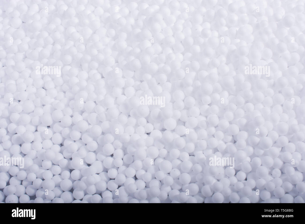 White little polystyrene foam balls as background Stock Photo - Alamy