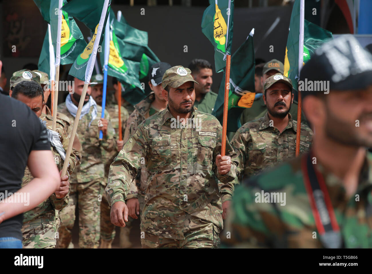 Baghdad, Iraq. 24th Apr, 2019. Members of the the predominantly Shia Muslim Popular Mobilization Forces (PMF) take part in a PMF conference to honour Iranian fighters who died fighting the so-called Islamic State (IS) terror group. Credit: Ameer Al Mohammedaw/dpa/Alamy Live News Stock Photo